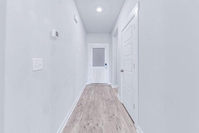 corridor with light hardwood / wood-style floors