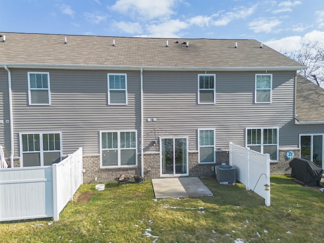 rear view of house featuring central AC, a yard, and a patio