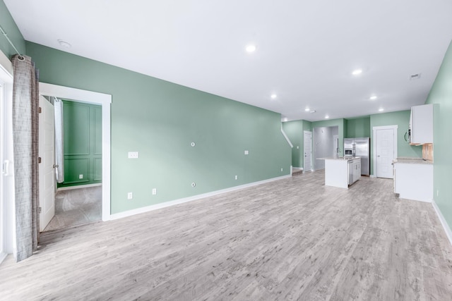 unfurnished living room with light wood-type flooring