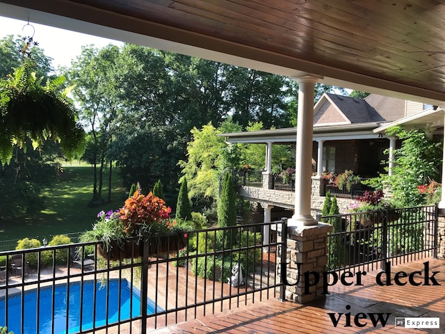 deck featuring a fenced in pool