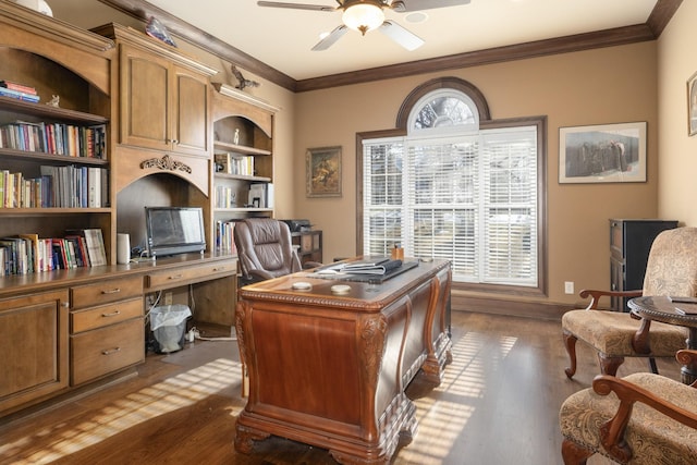 home office with ceiling fan, built in shelves, dark hardwood / wood-style flooring, and crown molding