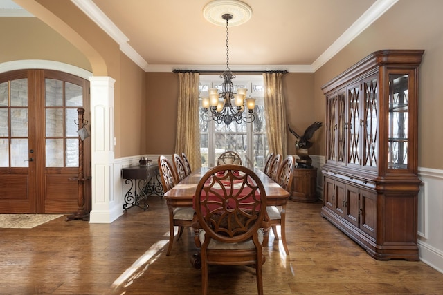 dining area with french doors, crown molding, dark hardwood / wood-style floors, and a notable chandelier