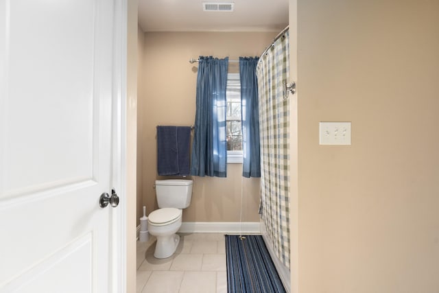 bathroom with toilet and tile patterned flooring