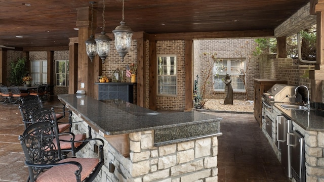 exterior space featuring wooden ceiling, brick wall, hanging light fixtures, a chandelier, and sink