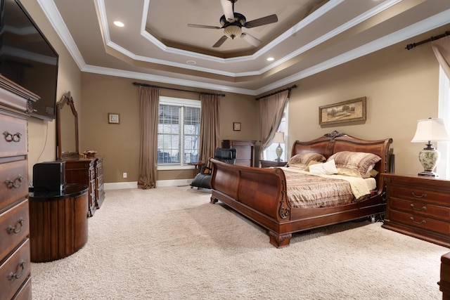 bedroom with ceiling fan, light carpet, crown molding, and a tray ceiling