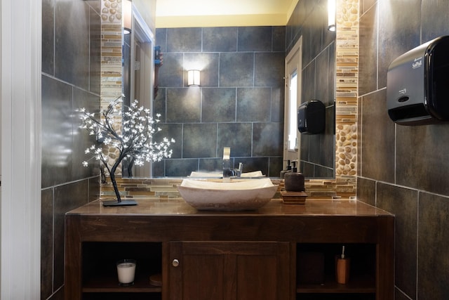 bathroom with decorative backsplash, tile walls, and vanity