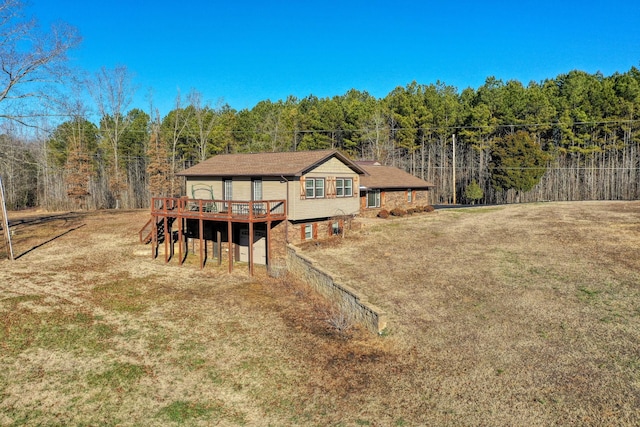 back of house with a deck and a yard