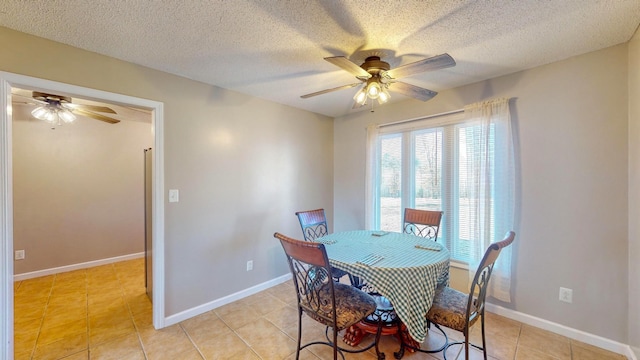 dining area featuring a textured ceiling, ceiling fan, and light tile patterned flooring