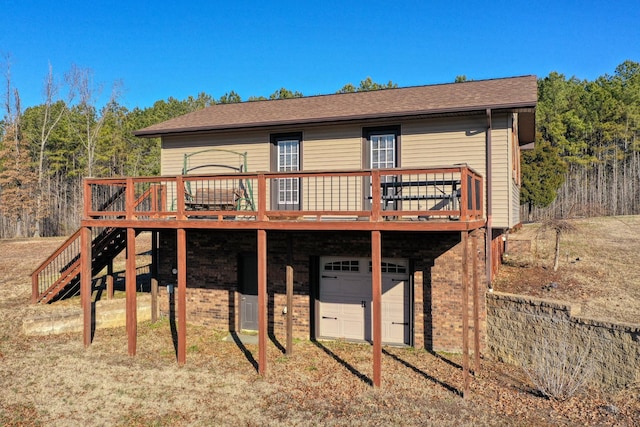 back of house featuring a wooden deck and a garage