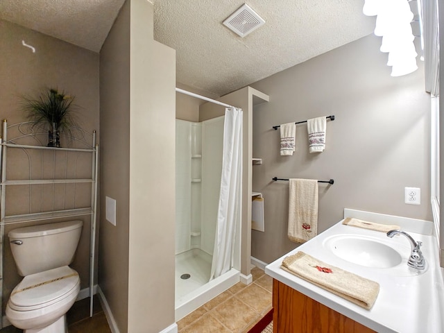 bathroom featuring toilet, vanity, tile patterned flooring, a textured ceiling, and curtained shower