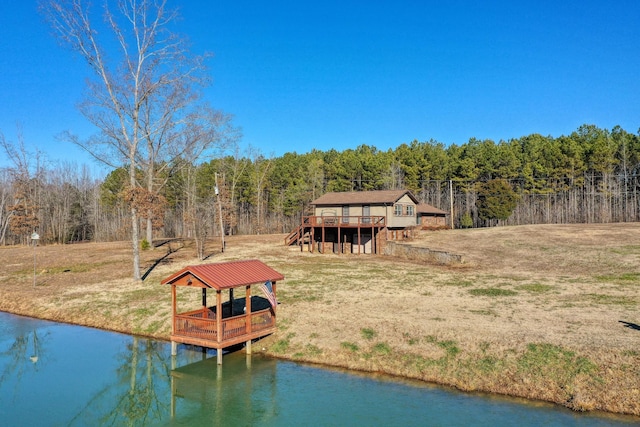 view of dock with a lawn and a deck with water view