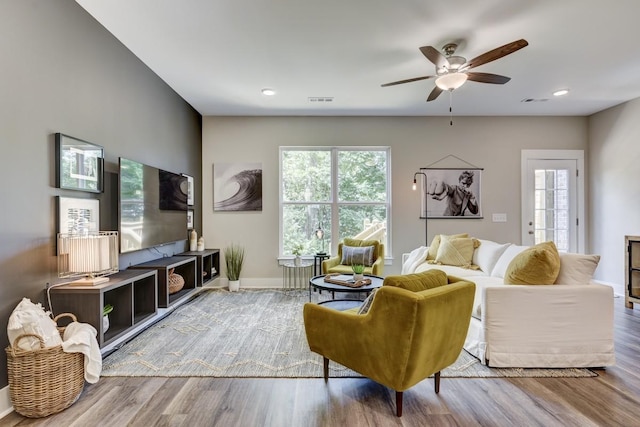 living room featuring ceiling fan and hardwood / wood-style flooring