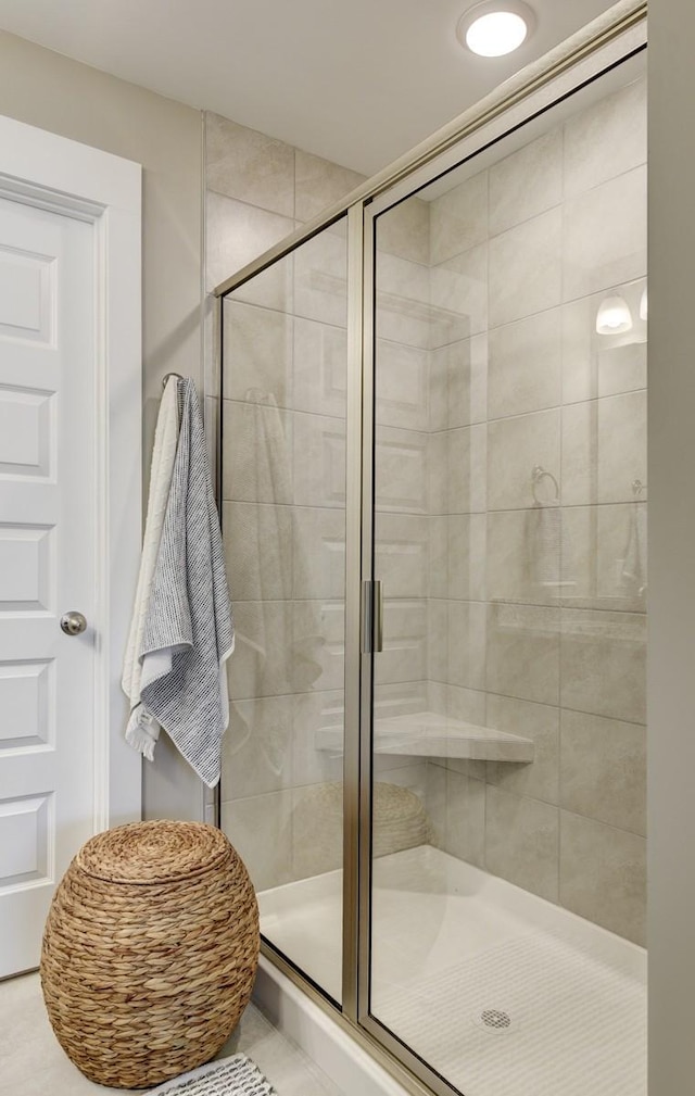 bathroom featuring an enclosed shower and tile patterned flooring