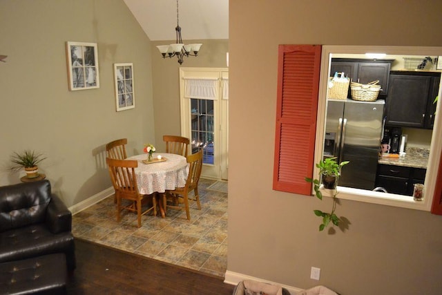 dining space featuring a chandelier and lofted ceiling