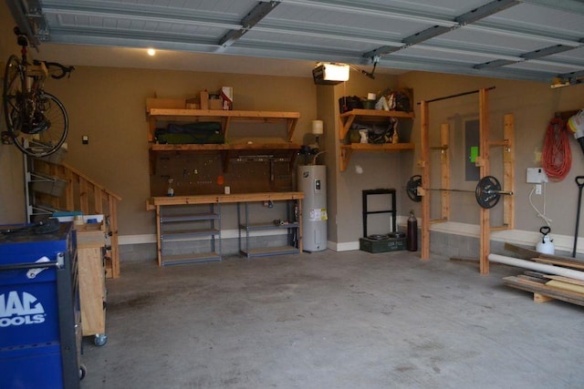 garage featuring a garage door opener, electric water heater, and a workshop area