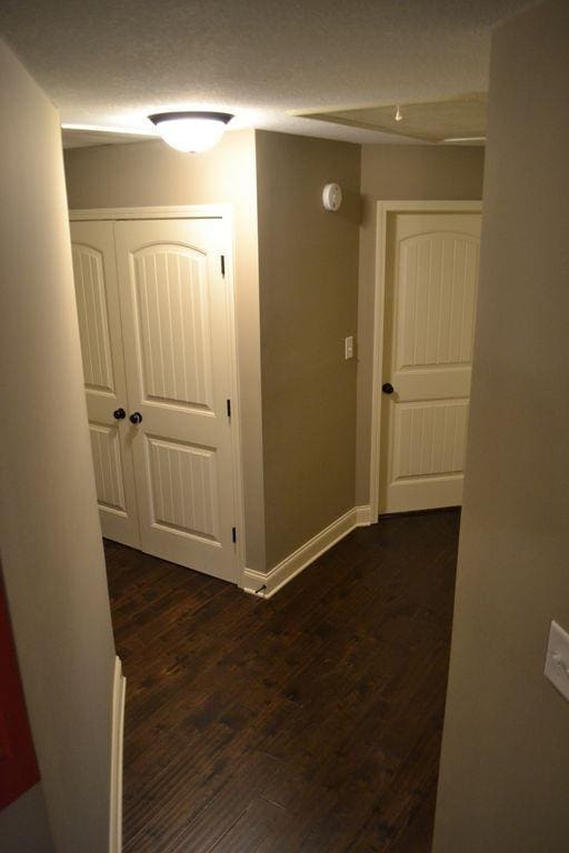 hall with dark hardwood / wood-style floors