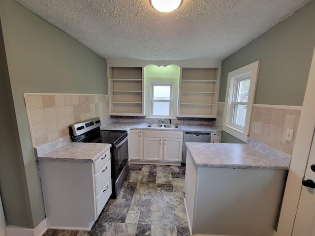 kitchen featuring sink, white cabinetry, plenty of natural light, appliances with stainless steel finishes, and a textured ceiling