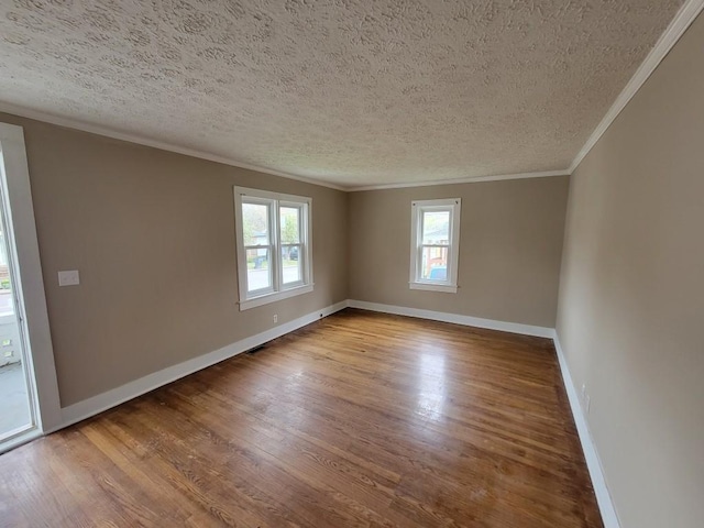 unfurnished room with light hardwood / wood-style floors, a textured ceiling, and crown molding