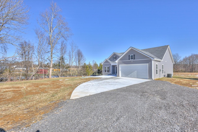 view of front of property with a garage and central AC unit