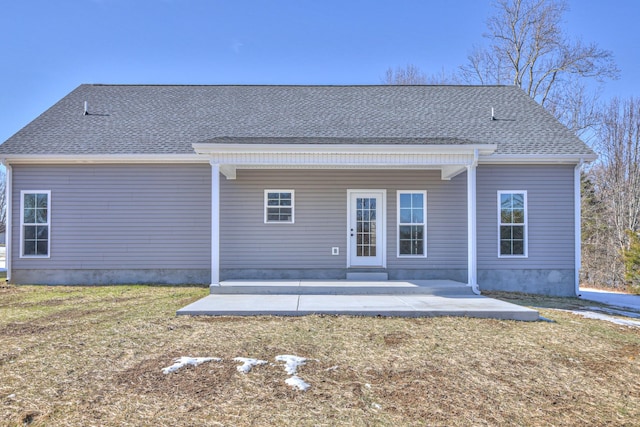 back of property featuring a yard and a patio