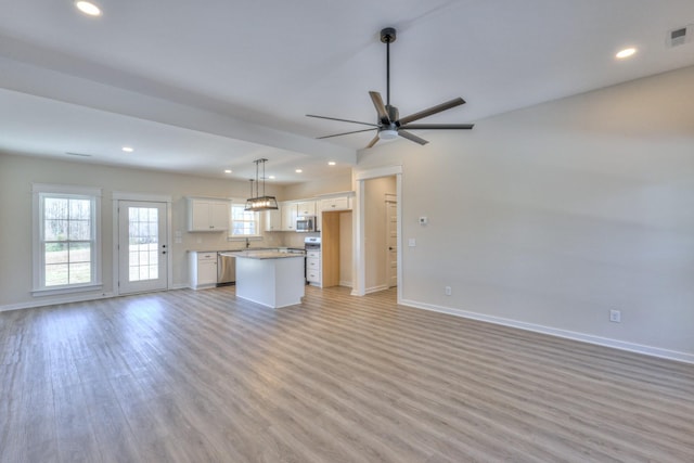 unfurnished living room featuring light hardwood / wood-style floors and ceiling fan