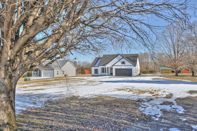 yard covered in snow with a garage