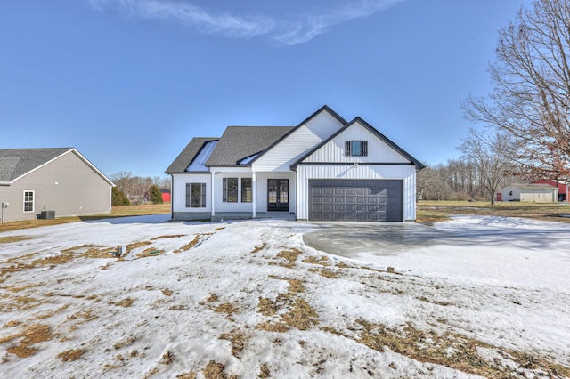 modern inspired farmhouse with a garage