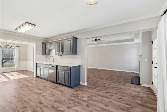 kitchen featuring ceiling fan with notable chandelier, gray cabinetry, dishwasher, and wood-type flooring