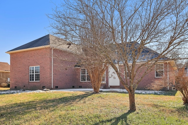 back of house with a yard and a patio