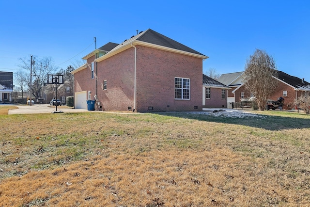 rear view of house with a lawn and a garage