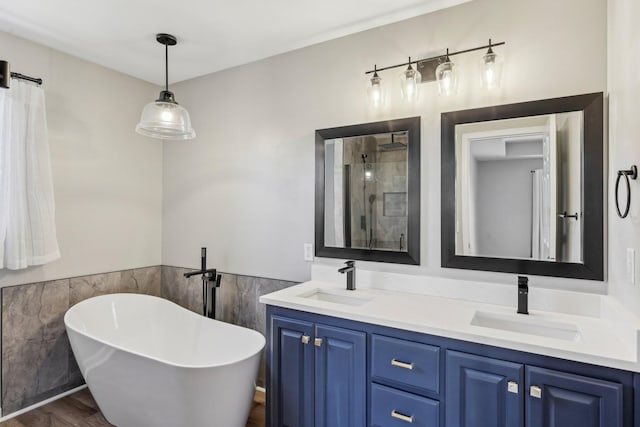 bathroom featuring vanity, tile walls, plus walk in shower, and wood-type flooring