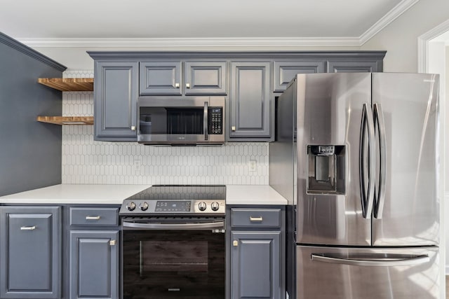 kitchen with decorative backsplash, appliances with stainless steel finishes, gray cabinetry, and crown molding