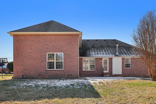 back of property with a patio area and a yard