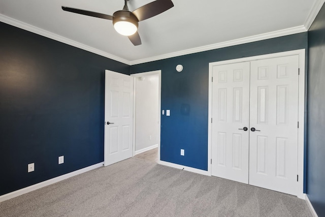 unfurnished bedroom featuring ceiling fan, light carpet, a closet, and crown molding