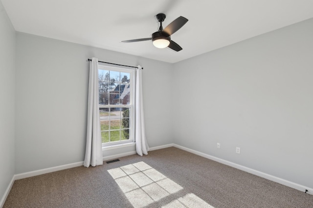 empty room featuring carpet floors, ceiling fan, and plenty of natural light