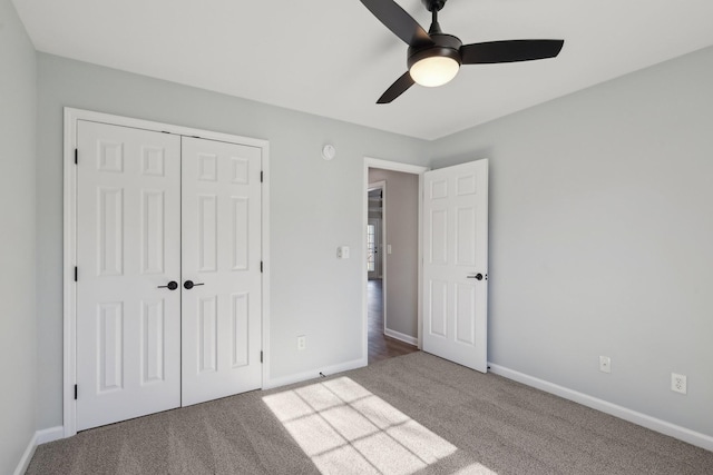 unfurnished bedroom with ceiling fan, a closet, and carpet floors