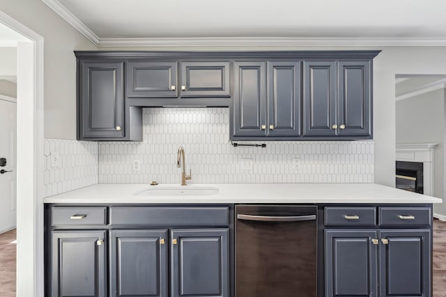 kitchen with dark hardwood / wood-style floors, tasteful backsplash, dishwasher, crown molding, and sink