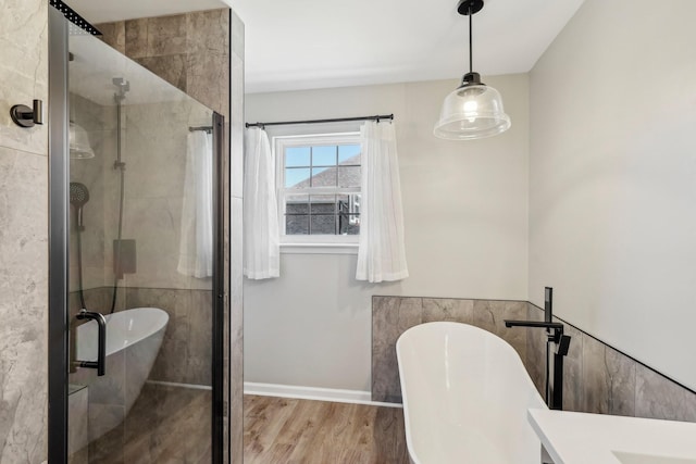 bathroom with independent shower and bath and hardwood / wood-style floors