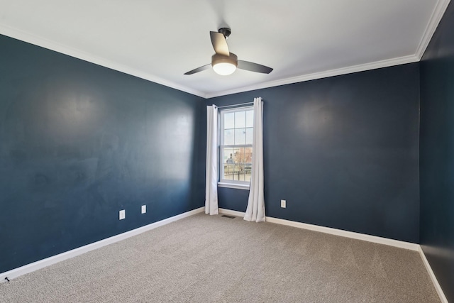 carpeted spare room with ceiling fan and crown molding