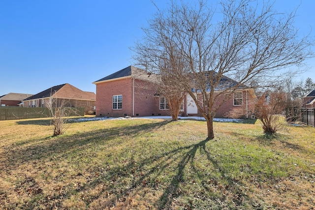 rear view of house featuring a lawn