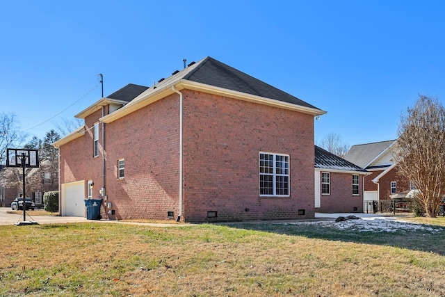 back of property featuring a garage and a yard