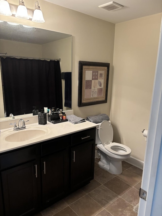 bathroom with tile patterned floors, toilet, and vanity