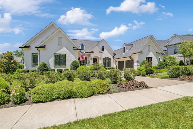 french country style house featuring a garage