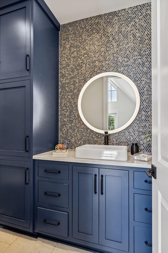 bathroom with decorative backsplash, vanity, and tile patterned flooring