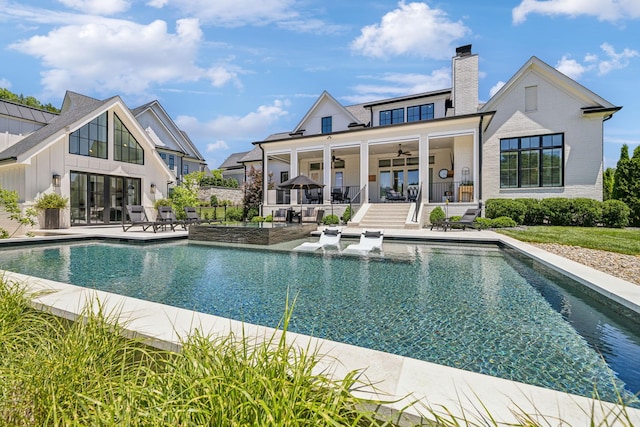 back of house with ceiling fan and a patio