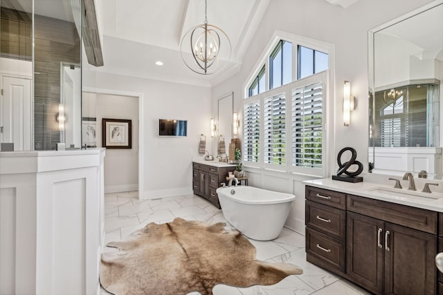 bathroom with a bathing tub, a healthy amount of sunlight, vanity, and a notable chandelier