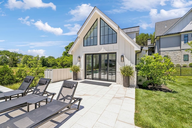 back of property featuring a patio area, a yard, and french doors