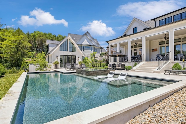 view of swimming pool featuring ceiling fan and a patio area