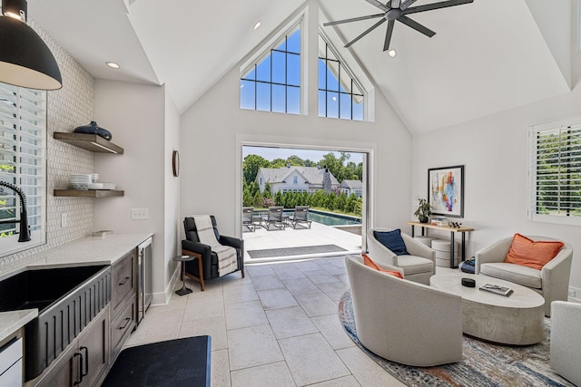 living room featuring high vaulted ceiling, ceiling fan, plenty of natural light, and sink