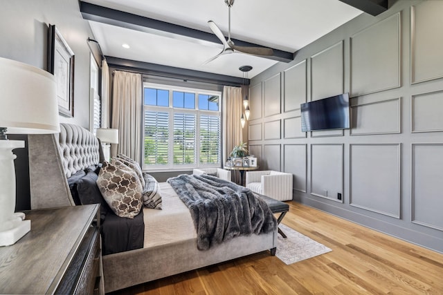 bedroom featuring light hardwood / wood-style flooring and beamed ceiling